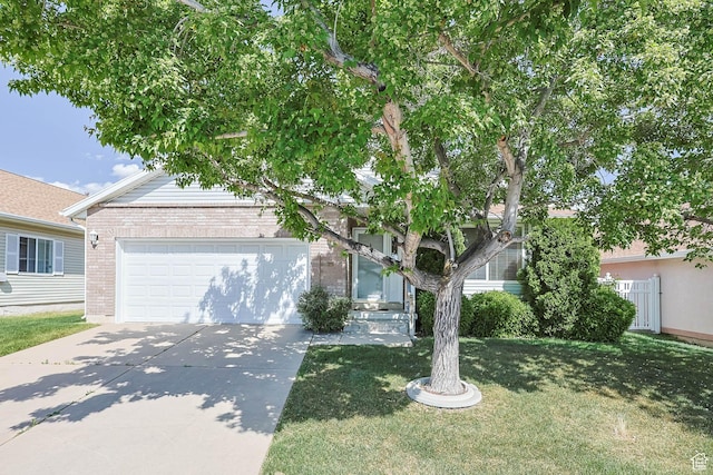 1660 E 900 S Unit 29, Clearfield, UT 84015 - view of property hidden behind natural elements featuring brick siding, driveway, an attached garage, and a front yard