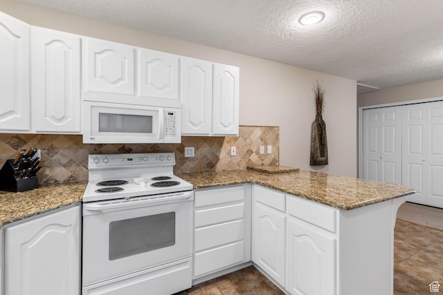 1660 E 900 S Unit 29, Clearfield, UT 84015 - kitchen featuring white appliances, a peninsula, a textured ceiling, white cabinetry, and backsplash