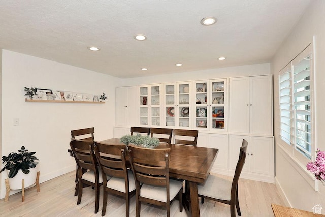 dining space with light wood finished floors, baseboards, and recessed lighting