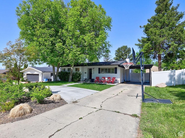 ranch-style house featuring driveway, a garage, and an attached carport