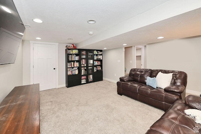 carpeted living area with recessed lighting, a textured ceiling, and baseboards