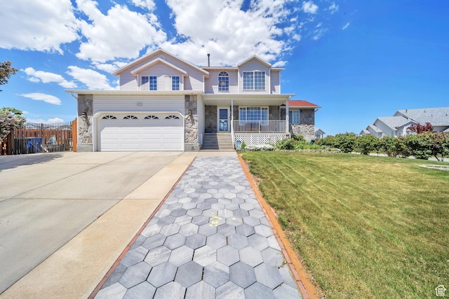 traditional home with a porch, stone siding, concrete driveway, and a garage
