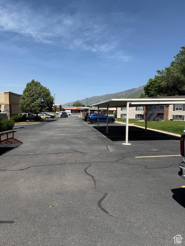 partially covered parking lot with a mountain view