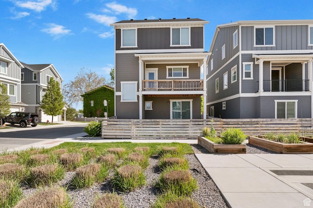 834 W Shelton Way, Midvale, UT 84047 - view of front of house with a garden, fence, a balcony, and stucco siding