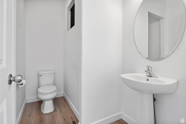 834 W Shelton Way, Midvale, UT 84047 - half bathroom with toilet, wood finished floors, and baseboards