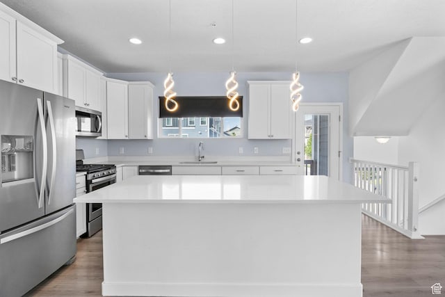 834 W Shelton Way, Midvale, UT 84047 - kitchen with appliances with stainless steel finishes, light countertops, a center island, recessed lighting, and white cabinets