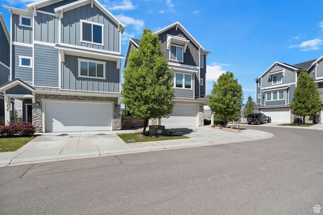 834 W Shelton Way, Midvale, UT 84047 - view of front facade featuring board and batten siding, stone siding, and a garage