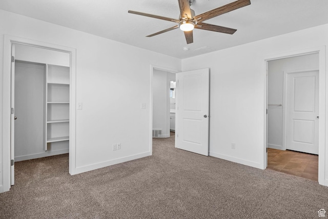 834 W Shelton Way, Midvale, UT 84047 - unfurnished bedroom with carpet floors, a walk in closet, baseboards, a closet, and a ceiling fan