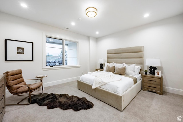 bedroom with light colored carpet, recessed lighting, and baseboards