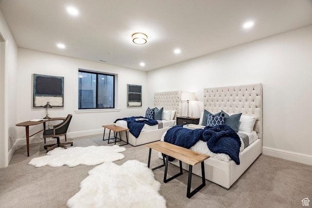 carpeted bedroom featuring baseboards and recessed lighting
