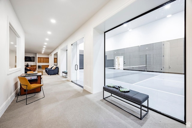 corridor featuring baseboards, recessed lighting, and carpet