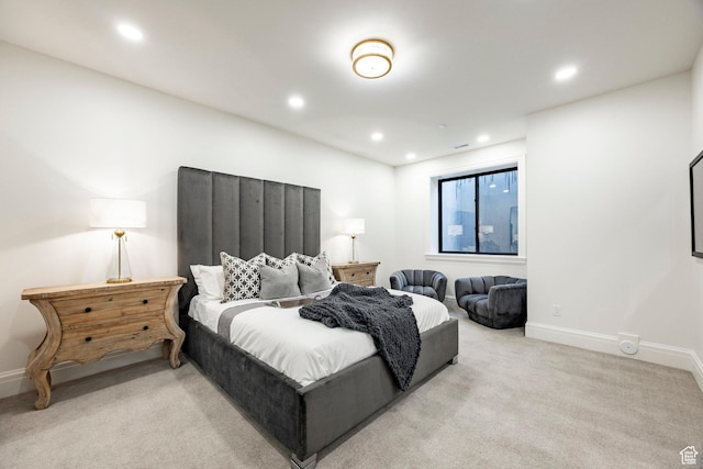 bedroom with recessed lighting, light colored carpet, and baseboards