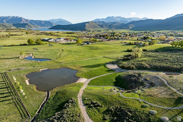 aerial overview of property's location with a water and mountain view and rural landscape