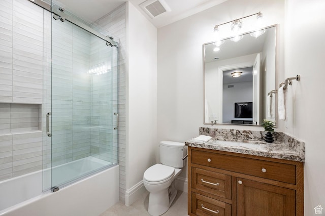 bathroom with toilet, vanity, shower / bath combination with glass door, and tile patterned flooring