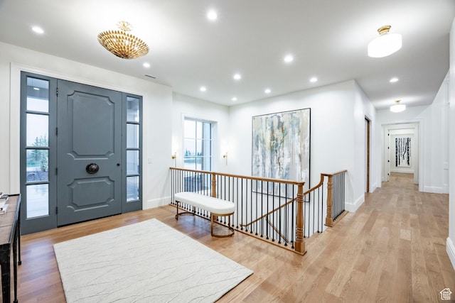 entryway with light wood-style floors, recessed lighting, and baseboards