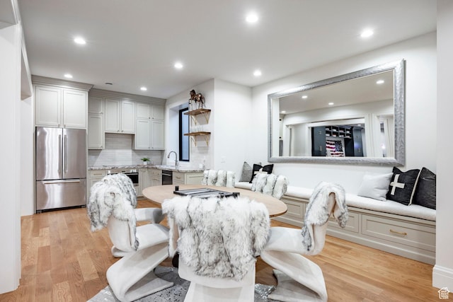 dining room featuring light wood-style flooring and recessed lighting