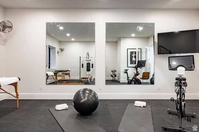exercise area featuring baseboards and recessed lighting