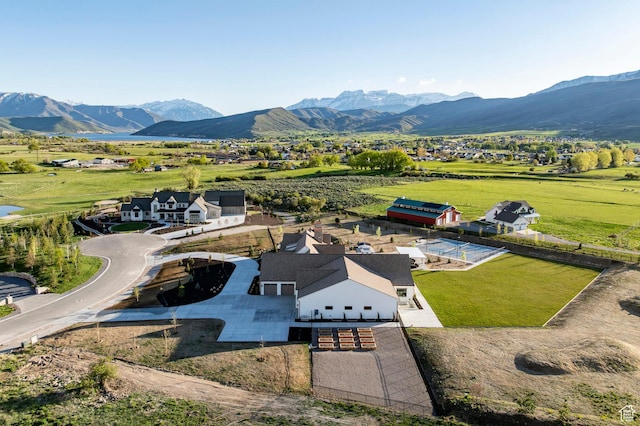 aerial view of property and surrounding area featuring a mountain backdrop
