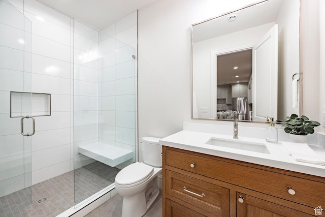 bathroom with a stall shower, toilet, and vanity