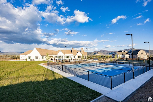 view of swimming pool with a tennis court