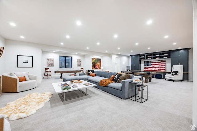 living room with recessed lighting and light carpet