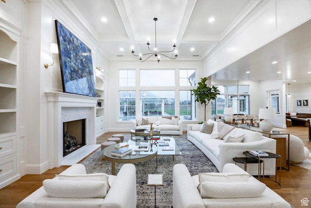 living area with a chandelier, coffered ceiling, wood finished floors, built in shelves, and beam ceiling