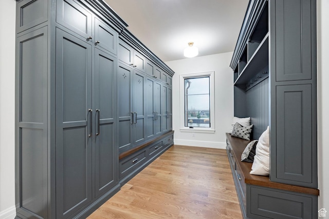 mudroom featuring light wood-type flooring and baseboards