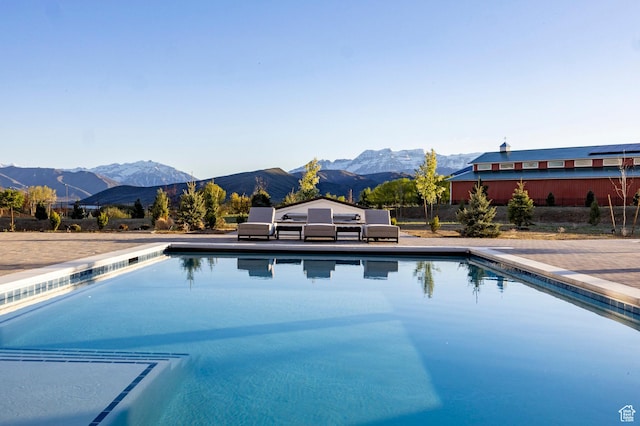 outdoor pool with a mountain view and fence