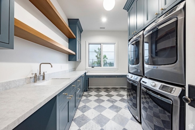 laundry area featuring stacked washing machine and dryer, cabinet space, and light flooring