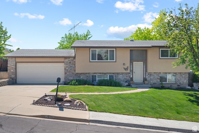 bi-level home featuring stucco siding, stone siding, a garage, and driveway