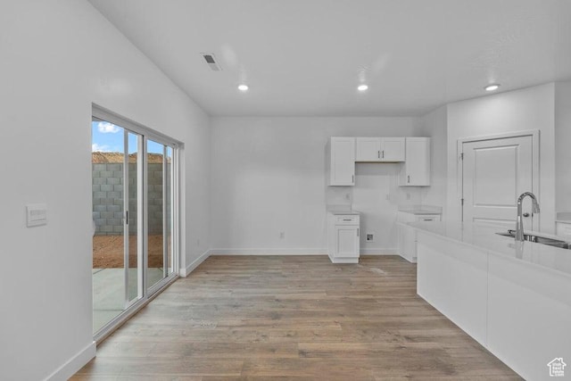 1448 S Staircase Way Unit 4099, Washington, UT 84780 - kitchen with a sink, white cabinets, light wood finished floors, baseboards, and recessed lighting