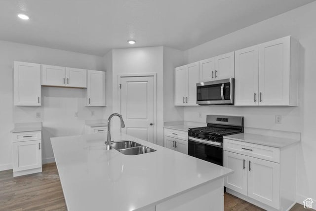 1448 S Staircase Way Unit 4099, Washington, UT 84780 - kitchen with appliances with stainless steel finishes, a sink, an island with sink, white cabinetry, and dark wood-style flooring