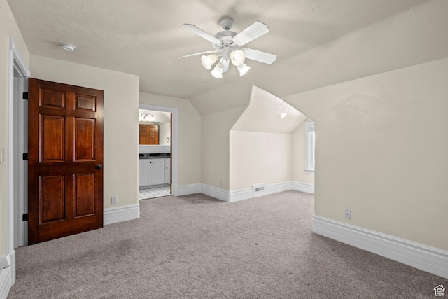 bonus room featuring carpet, a ceiling fan, lofted ceiling, and baseboards