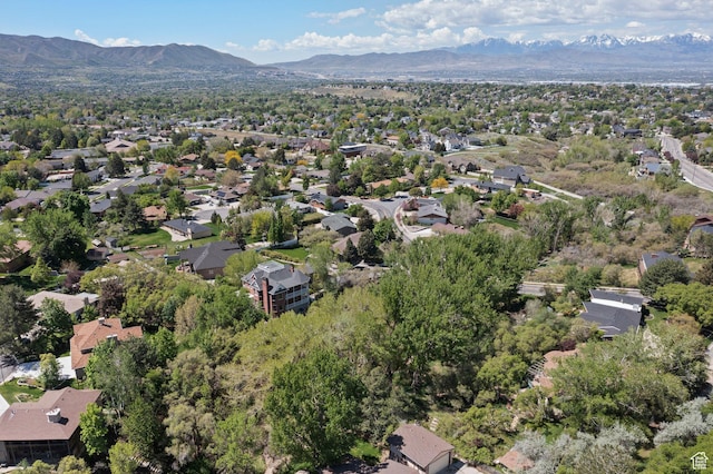 view of property location featuring mountains and nearby suburban area