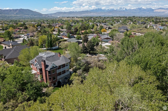 aerial overview of property's location with a mountain backdrop and nearby suburban area