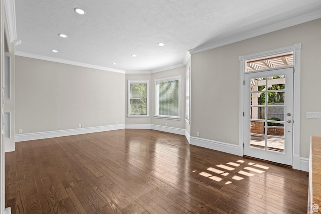 unfurnished living room with wood-type flooring, recessed lighting, baseboards, ornamental molding, and a textured ceiling
