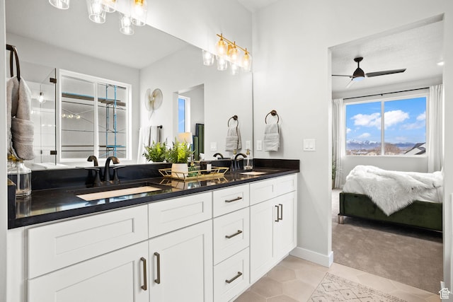 full bathroom featuring tile patterned floors, double vanity, a ceiling fan, and baseboards