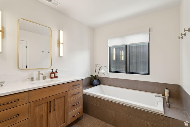 bathroom featuring vanity, a garden tub, and tile patterned floors
