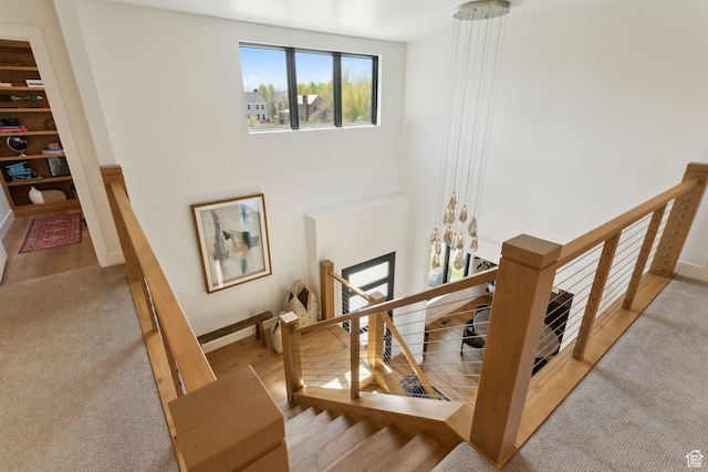 stairs with wood finished floors and baseboards