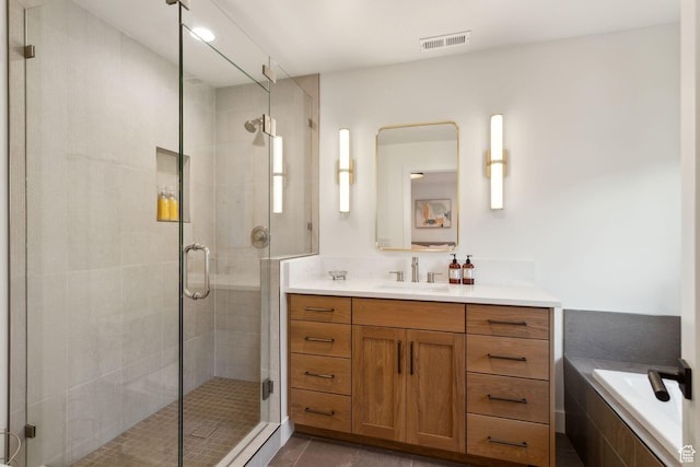 full bathroom with a stall shower, vanity, tile patterned floors, and tiled bath