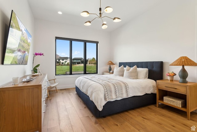 bedroom with light wood-style flooring, a chandelier, baseboards, and recessed lighting