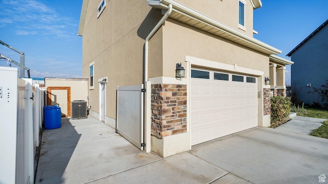 186 W 380 S, American Fork, UT 84003 - view of side of property with a gate, a garage, central AC unit, and stucco siding