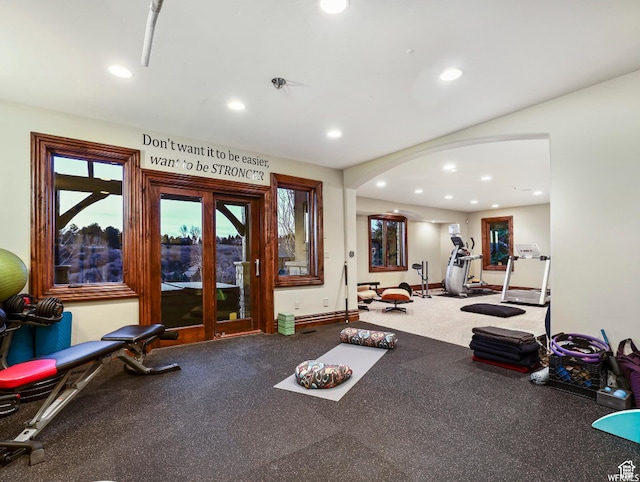 exercise room with arched walkways, recessed lighting, healthy amount of natural light, and baseboards