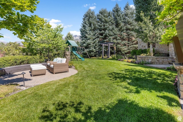 view of green lawn with a playground, a patio, and outdoor lounge area