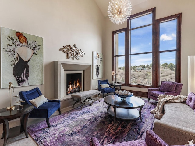 sitting room with a lit fireplace and a chandelier
