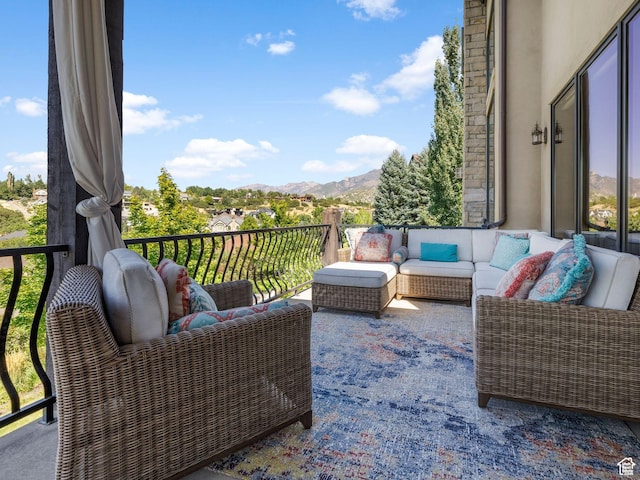 balcony with an outdoor hangout area and a mountain view