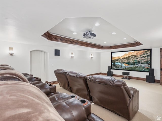 carpeted cinema room featuring a tray ceiling, recessed lighting, and ornamental molding