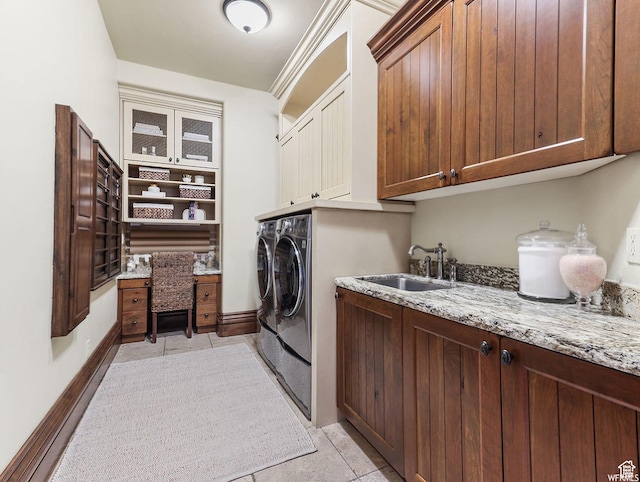 laundry area featuring cabinet space, separate washer and dryer, and light tile patterned flooring