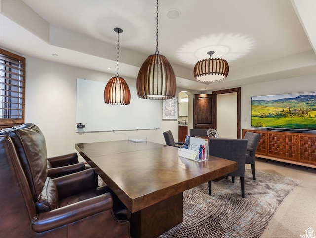 carpeted office space featuring a raised ceiling and recessed lighting