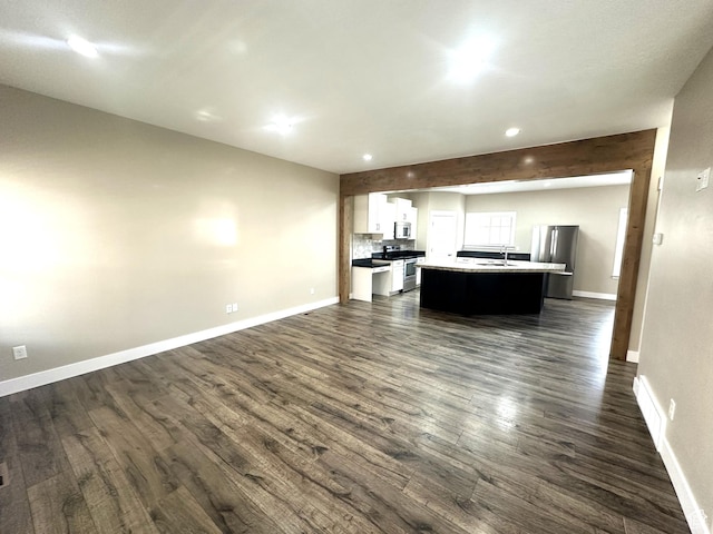 5516 W Florence Ln N, Highland, UT 84003 - unfurnished living room featuring dark wood-style floors and recessed lighting